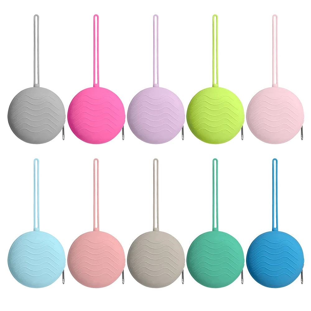 A row of ten silicone pacifier holders and soother cases in various shades of pink, green, blue, and gray.