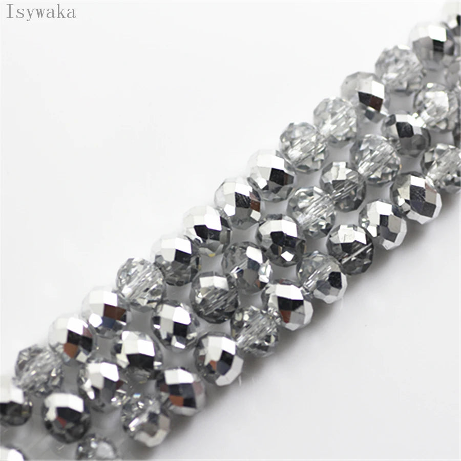A close-up of silver and clear crystal glass beads used as round spacers for jewelry making.