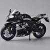A black Suzuki GSX-R1000R diecast motorcycle model in a studio setting.