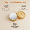 A round white squishy toy is shown in a yellow container, illustrating features like cute shape and soft TPR material.