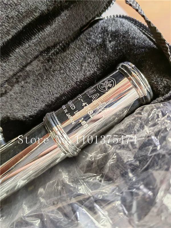Silver plated flute with e-key inside a black padded case.
