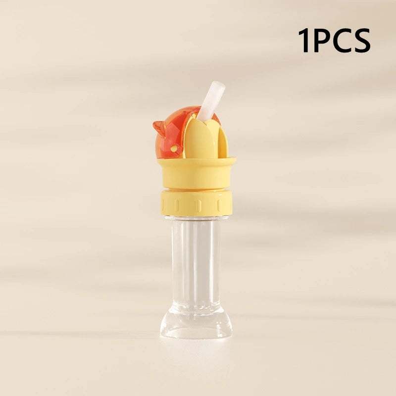 A 1 piece anti-choking straw and bottle cap converter for kids, featuring an orange top and yellow base.