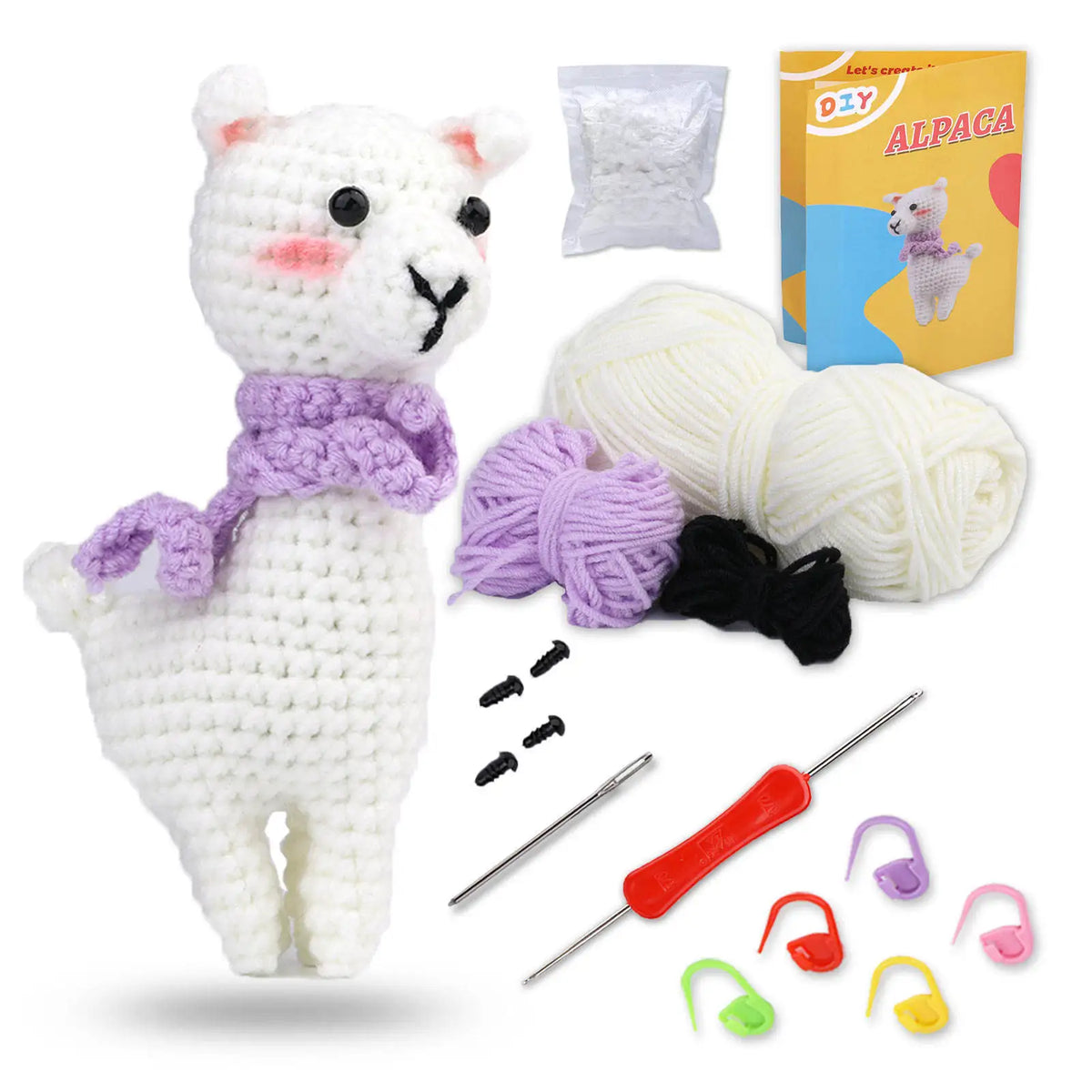 A white alpaca crochet toy with purple accents, yarn, needles, and accessories for crafting.