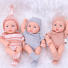 A set of realistic soft vinyl reborn baby dolls dressed in striped and polka dot clothing