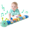 A baby is interacting with a soft musical rattle caterpillar plush toy made of colorful fabric.