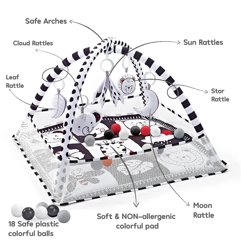 A play mat featuring safe arches, various rattles like cloud and sun rattles, and colorful balls for baby play.
