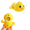 A yellow wind-up swimming duck bath toy for toddlers shown from above and held in a hand.