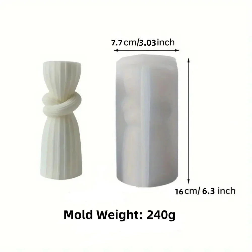 A white silicone mold shaped like a twisted ribbon for making pillar candles.