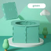 A light green foldable baby potty training seat is shown on a white stand with a green tree in the background.