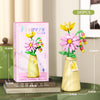 A set of 149 flower bouquet building blocks with a vase, featuring pink and yellow flowers for home decor.