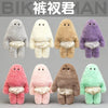 A collection of seven soft plush monster dolls in various colors including gray, cream, tan, purple, pink, brown, and green.