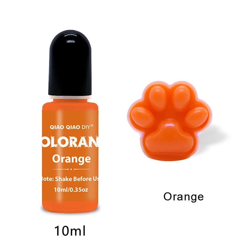 A small amber bottle of orange liquid pigment labeled QIAO QIAO DIY with an orange paw print shape nearby.