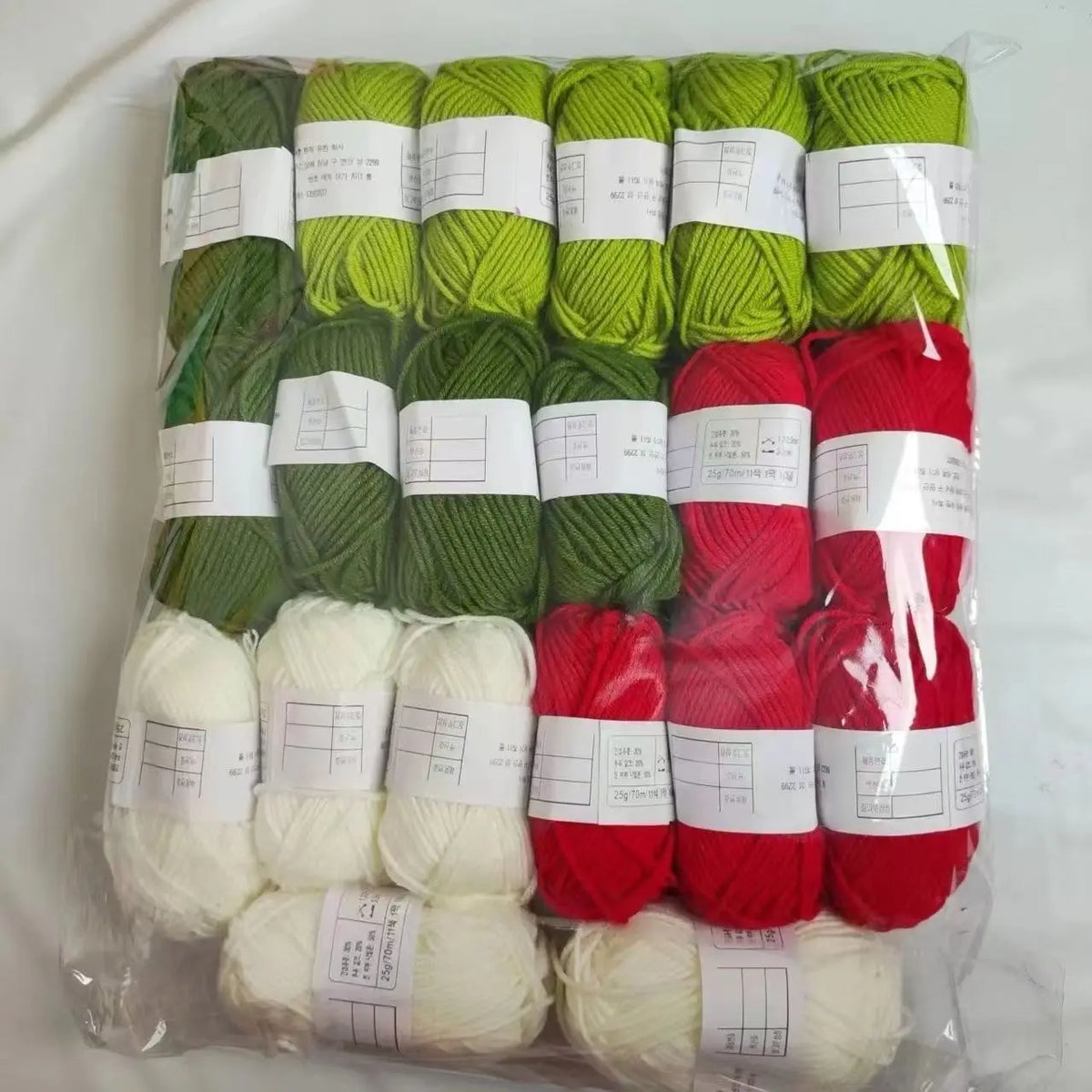 A pack of 20 skeins of milk cotton blend yarn in various shades of green and red for knitting and crochet.