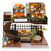 A wooden miniature dollhouse assembly kit featuring furniture and decorative elements.