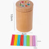A wooden color sorting set for toddlers with various colored rings and a cylindrical container.