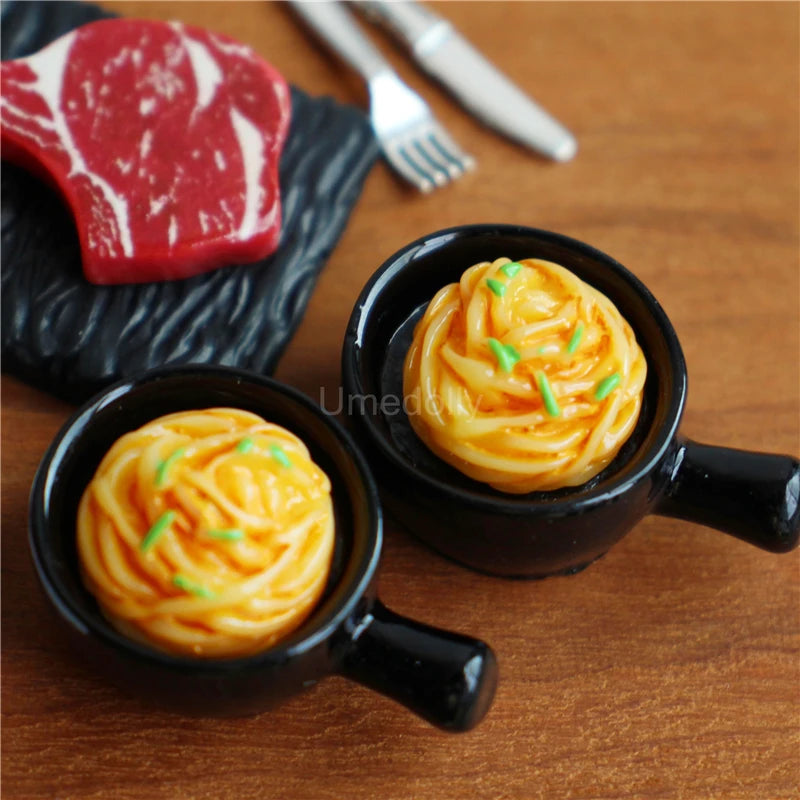 A miniature dollhouse set featuring a beef steak and pasta food item on a wooden table.