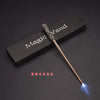 A dark wooden magic wand with a textured handle and a glowing blue tip is displayed on a dark surface.