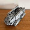 A gray plastic building blocks set depicting an Imperial Troop Transport vehicle.