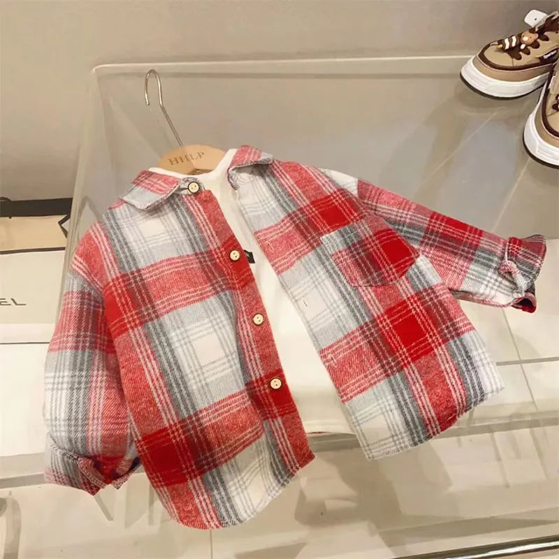 A red and gray plaid button-up shirt displayed on a clear shelf.