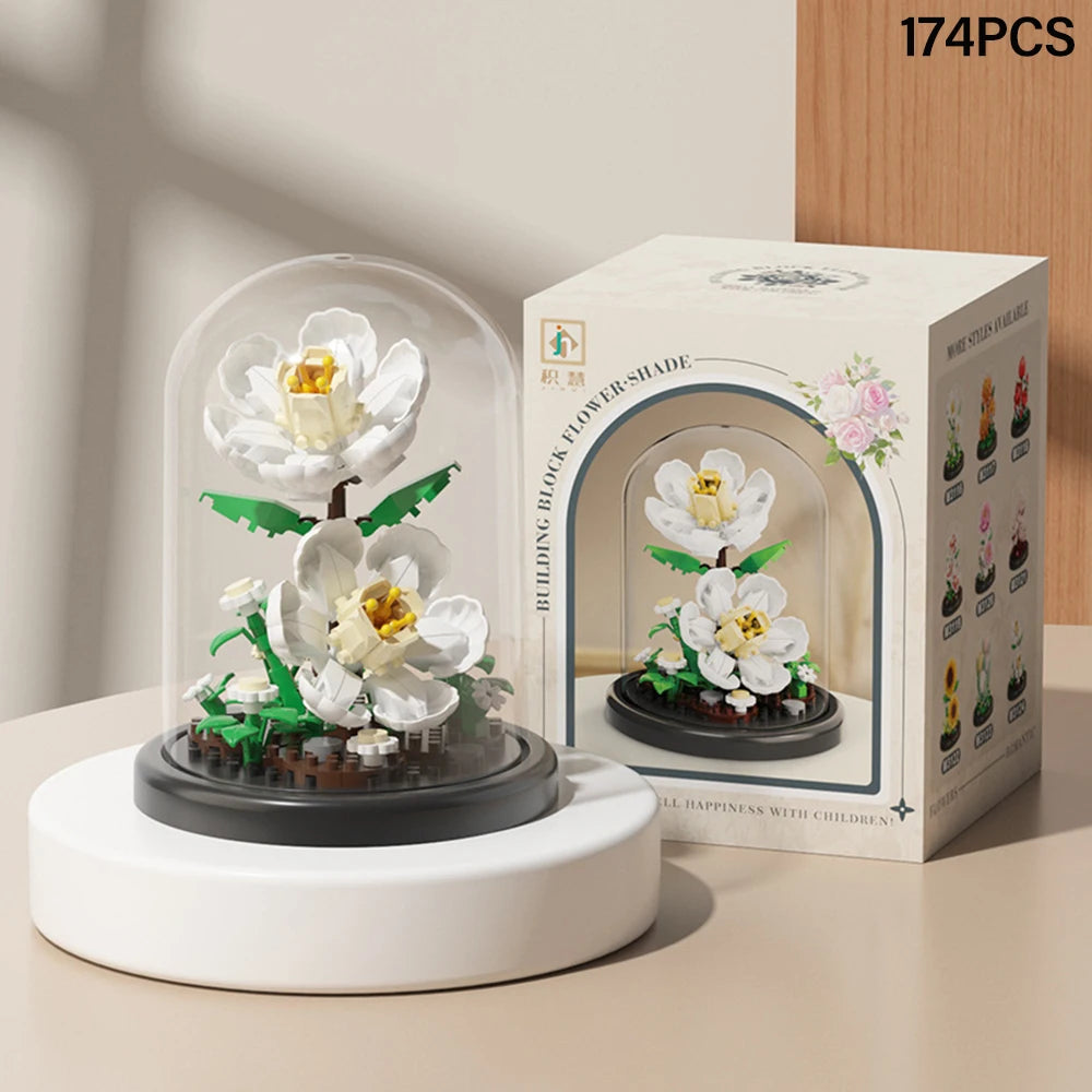A box of 174 pieces of DIY micro building blocks forming an eternal flower garden with a dust cover and a white flower displa