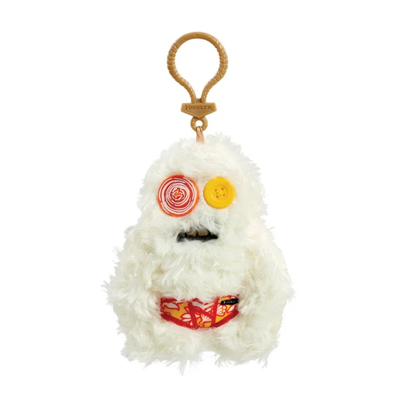 A white fluffy plush monster keychain with a yellow eye and red striped pattern.