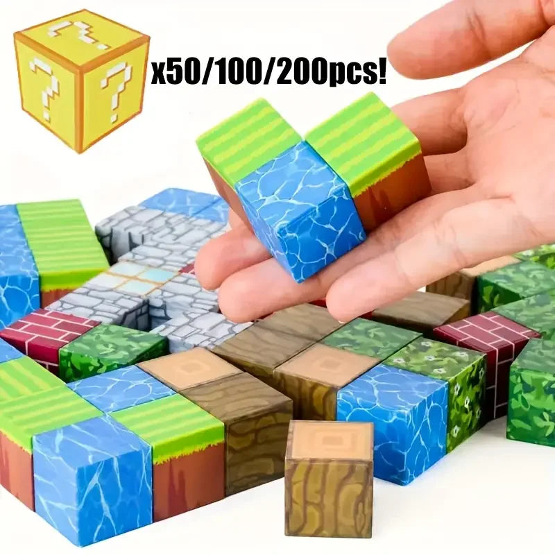 A hand holds colorful magnetic building cubes in various shades of green, blue, and brown.