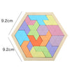A wooden tangram puzzle board with colored geometric shapes arranged in a hexagonal pattern.