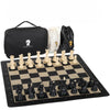 A portable folding chess set with weighted pieces displayed on a black board next to a black carrying bag and a white cloth b