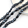 Black heart-shaped acrylic beads strung together for jewelry making