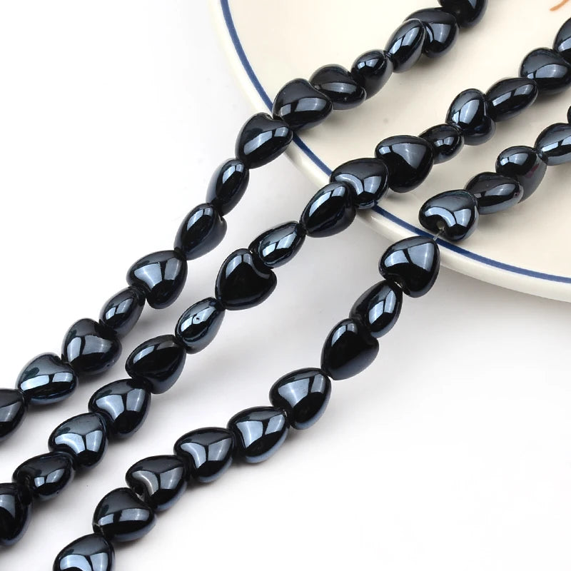 Black heart-shaped acrylic beads strung together for jewelry making