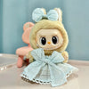 A cute, light yellow doll wearing a light blue bow and a matching dress with lace trim.