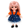 A pink-haired BJD princess doll wearing an orange top and a blue patterned dress.