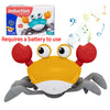 A yellow and black electric crab toy with large eyes and claws is shown next to its packaging.