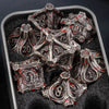 A set of seven metal dice shaped like skulls and dragons for tabletop role-playing games