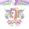 A set of pink and purple unicorn balloons shaped like the number seven and a rainbow