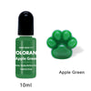 A green glass bottle of Oloran Apple Green liquid pigment with a black cap and a green paw print stamp.