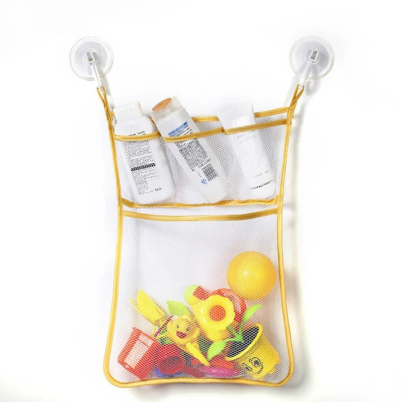 A white mesh storage bag with suction cups holds various bath and shower items, including toiletries and toys.