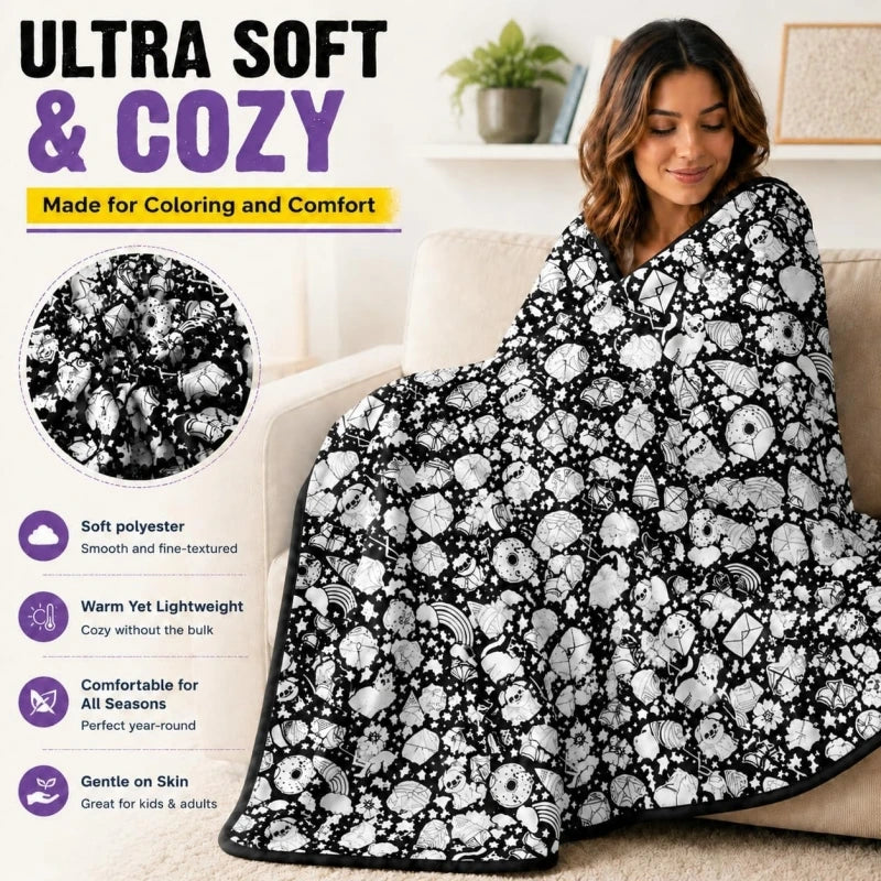 A woman is relaxing on a couch with a black and white patterned soft blanket for coloring and comfort.