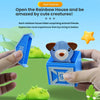 Hands open a blue box revealing a gray animal toy for toddlers, part of a Rainbow House surprise.