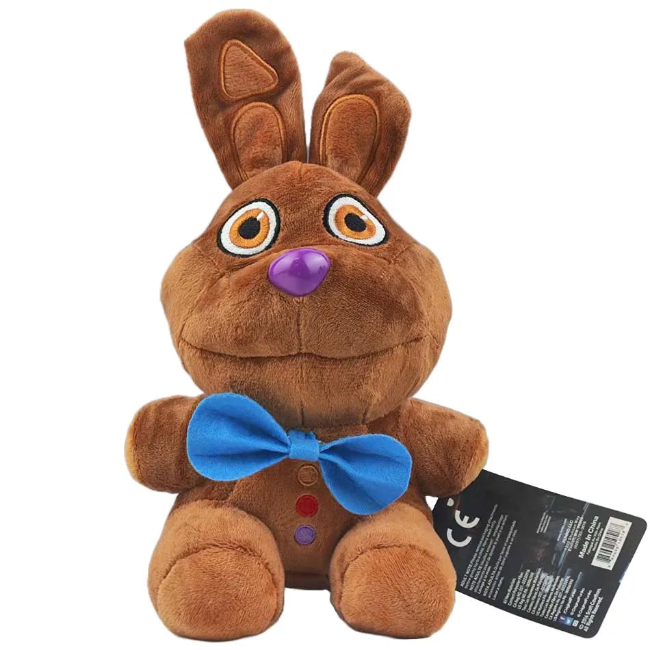 A brown plush toy resembling a rabbit with large eyes and a blue bow.