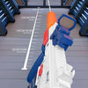 A close-up view of an electric water blaster toy gun being fired, demonstrating its range with a measuring scale.