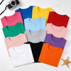 A collection of colorful, soft cotton kids t-shirts in various shades including pink, yellow, blue, green, and red.
