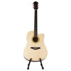 A light-colored acoustic guitar is displayed on a foldable metal stand.