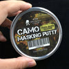 A hand holds a tin of Camo Masking Putty labeled ZERO BLACK COLOR for model painting.