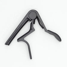 A black aluminum alloy quick-change guitar capo with a hinged design.
