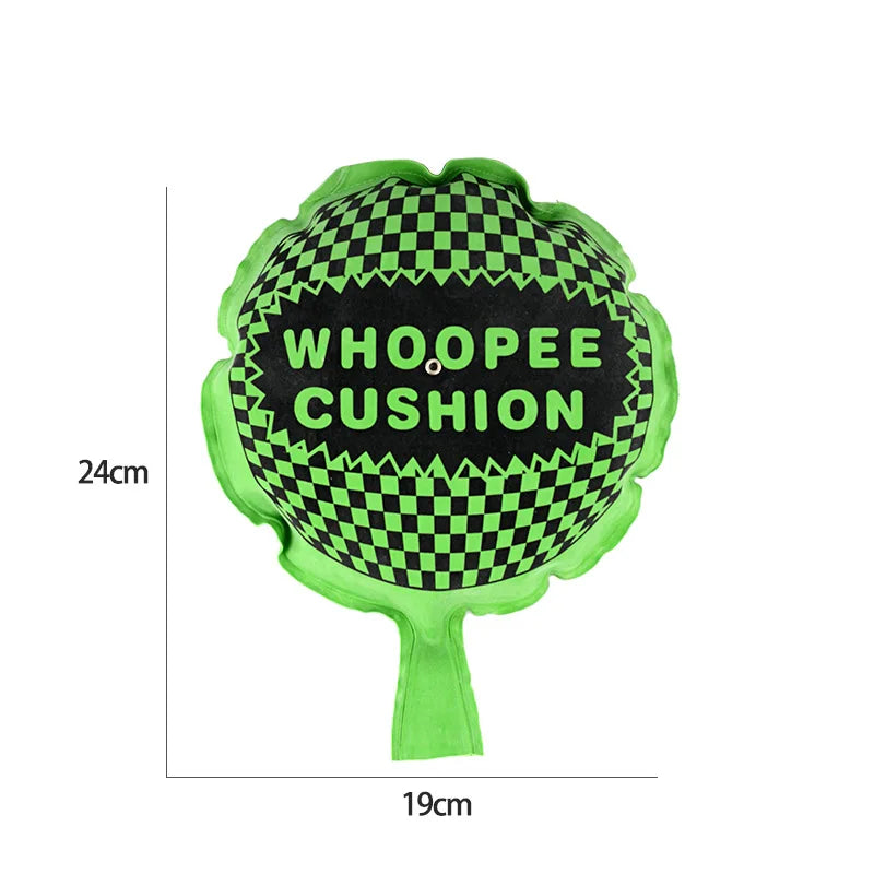 A bright green cushion shaped like a tree with a black and green checkered pattern, labeled WHOOPEE CUSHION.