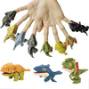 A hand is holding various finger dinosaur fidget toys, including a large tyrannosaurus and smaller reptiles.