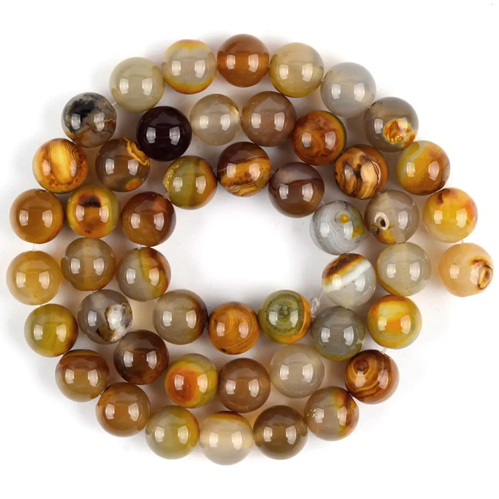 A circular arrangement of natural sea sediment jasper and turquoise beads for jewelry making