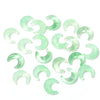A collection of translucent green moon-shaped glass beads for DIY jewelry making
