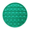 A circular green silicone fidget toy with multiple raised bubbles for sensory play and stress relief.